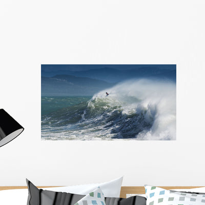 Person Surfing Waves along Wall Mural shown on a wall