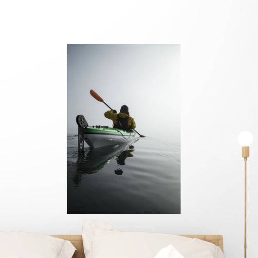 A Sea Kayaker Paddles Into Thick Fog On On A Calm Morning Wall Mural