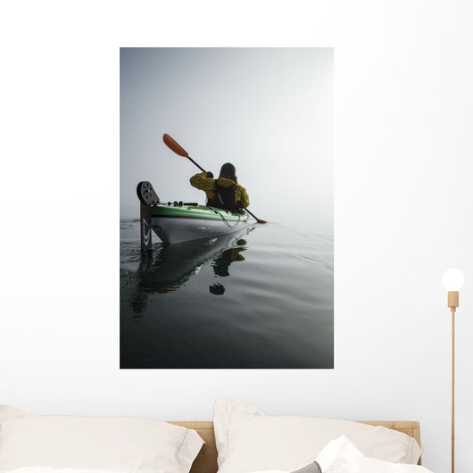 A Sea Kayaker Paddles Into Thick Fog On On A Calm Morning Wall Mural