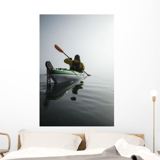 A Sea Kayaker Paddles Into Thick Fog On On A Calm Morning Wall Mural
