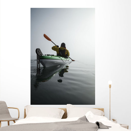 A Sea Kayaker Paddles Into Thick Fog On On A Calm Morning Wall Mural