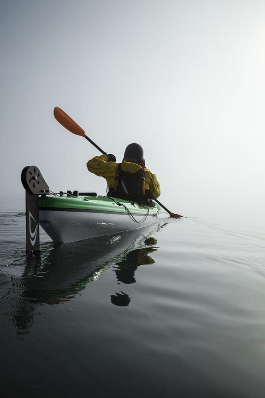 A Sea Kayaker Paddles Into Thick Fog On On A Calm Morning Wall Mural