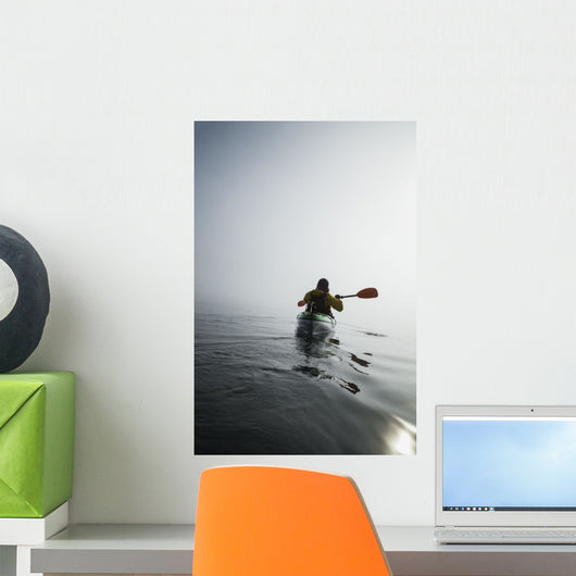 A Sea Kayaker Paddles Into Thick Fog On On A Calm Morning Wall Mural