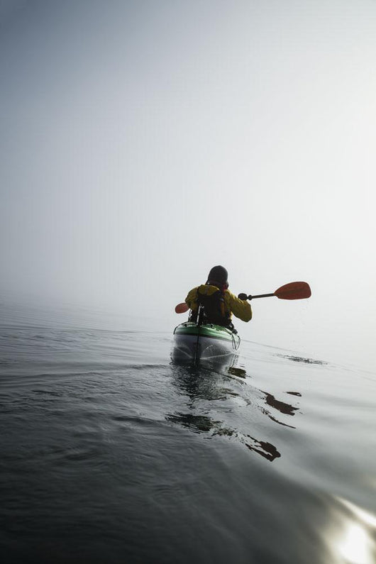 A Sea Kayaker Paddles Into Thick Fog On On A Calm Morning Wall Mural