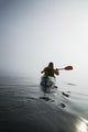 A Sea Kayaker Paddles Into Thick Fog On On A Calm Morning Wall Mural