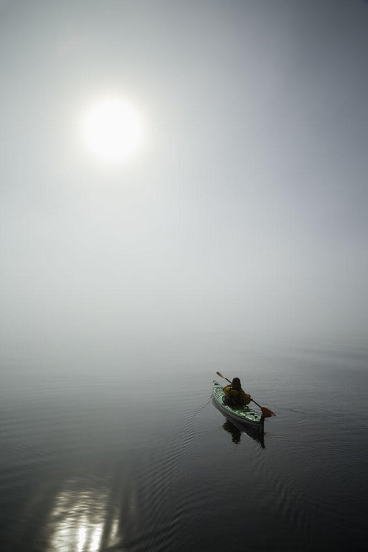 A Sea Kayaker Paddles Into Thick Fog On On A Calm Morning Wall Mural