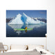 A Sea Kayaker Paddles Beside An Iceberg Wall Mural