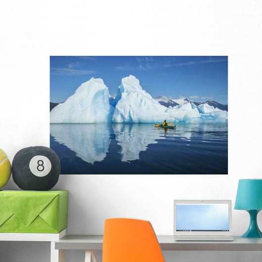 A Sea Kayaker Paddles Beside An Iceberg Wall Mural