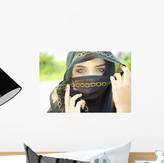 A Woman's Eyes Peering Out From A Headscarf Wall Mural