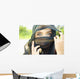 A Woman's Eyes Peering Out From A Headscarf Wall Mural