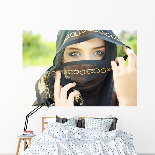 A Woman's Eyes Peering Out From A Headscarf Wall Mural