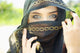 A Woman's Eyes Peering Out From A Headscarf Wall Mural