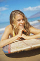A Young Woman Lays On A Surfboard On The Sand Wall Mural