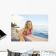 A Young Woman Wearing A Lei Rides A Surfboard Out In The Water Wall Mural