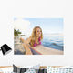 A Young Woman Wearing A Lei Rides A Surfboard Out In The Water Wall Mural