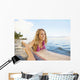 A Young Woman Wearing A Lei Rides A Surfboard Out In The Water Wall Mural