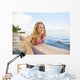 A Young Woman Wearing A Lei Rides A Surfboard Out In The Water Wall Mural