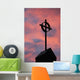 Silhouette of a cross on church steeple with fiery cloud cover Wall Mural