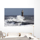 Waves crashing into a lighthouse Wall Mural
