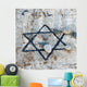 A star of david etched and painted on a rock with stones laying on it Wall Mural