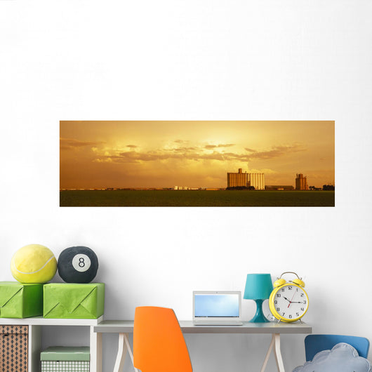 Agriculture - Grain elevators and an early growth corn field Wall Mural