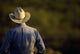 Agriculture - View of a cowboy from behind / Cee Vee, Texas, USA Wall Mural