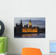 A Building And Clock Tower Along The Water's Edge Illuminated At Dusk Wall Mural