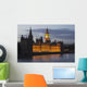 A Building And Clock Tower Along The Water's Edge Illuminated At Dusk Wall Mural