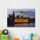 A Building And Clock Tower Along The Water's Edge Illuminated At Dusk Wall Mural