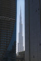 Looking between two tall office buildings to the Burj Khalifa Wall Mural