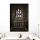 Stained glass windows and a table surrounded with candles in a church Wall Mural