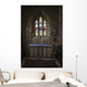 Stained glass windows and a table surrounded with candles in a church Wall Mural