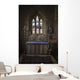 Stained glass windows and a table surrounded with candles in a church Wall Mural