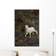 A young bighorn sheep standing among rocks and grass Wall Mural