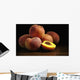 Peaches sitting on a wooden table, one cut in half Wall Mural