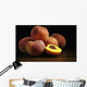 Peaches sitting on a wooden table, one cut in half Wall Mural