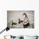A mother mallard guards her ducklings Wall Mural