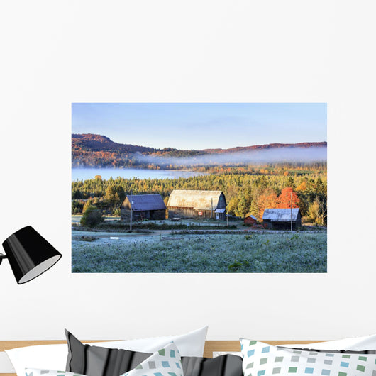 Rustic buildings and barn among autumn colors at sunrise Wall Mural
