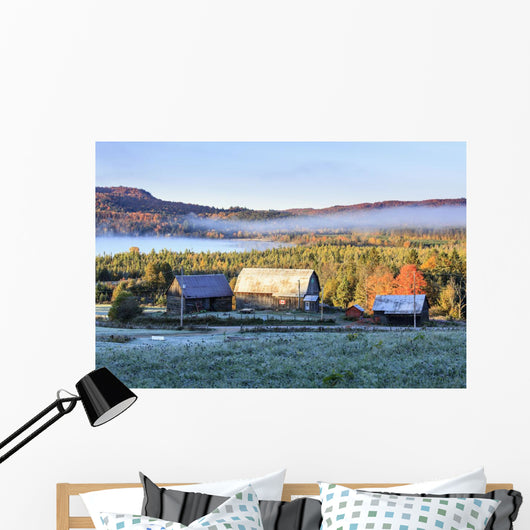 Rustic buildings and barn among autumn colors at sunrise Wall Mural