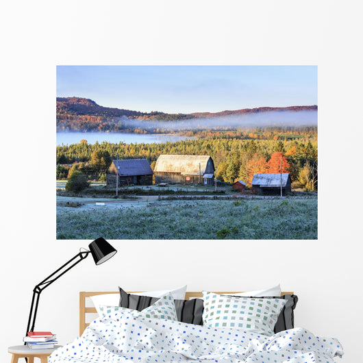 Rustic buildings and barn among autumn colors at sunrise Wall Mural