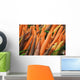 Green plastic baskets with freshly picked organic carrots for sale Wall Mural
