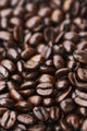 Medium dark roast Kona coffee beans close up Wall Mural