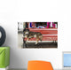 Dog sleeping on a red bench Wall Mural