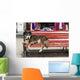 Dog sleeping on a red bench Wall Mural