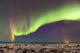 Northern Lights in the sky above the snow covered mudflats of Knik Arm Wall Mural
