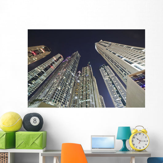 Skyscrapers illuminated at nighttime Wall Mural