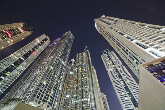 Skyscrapers illuminated at nighttime Wall Mural