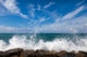 The waves breaking on a stony beach Wall Mural