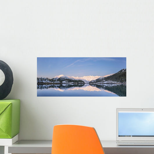 Snowy scenic reflected in the waters of Harrison Lagoon at sunrise Wall Mural