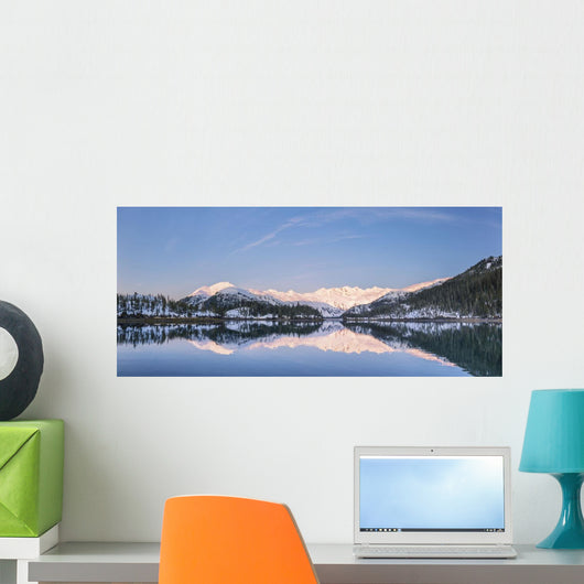Snowy scenic reflected in the waters of Harrison Lagoon at sunrise Wall Mural